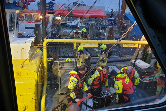 Redders en brandweerlieden met pompen in de weer op een kotter die water maakte. (Foto KNRM Breskens)